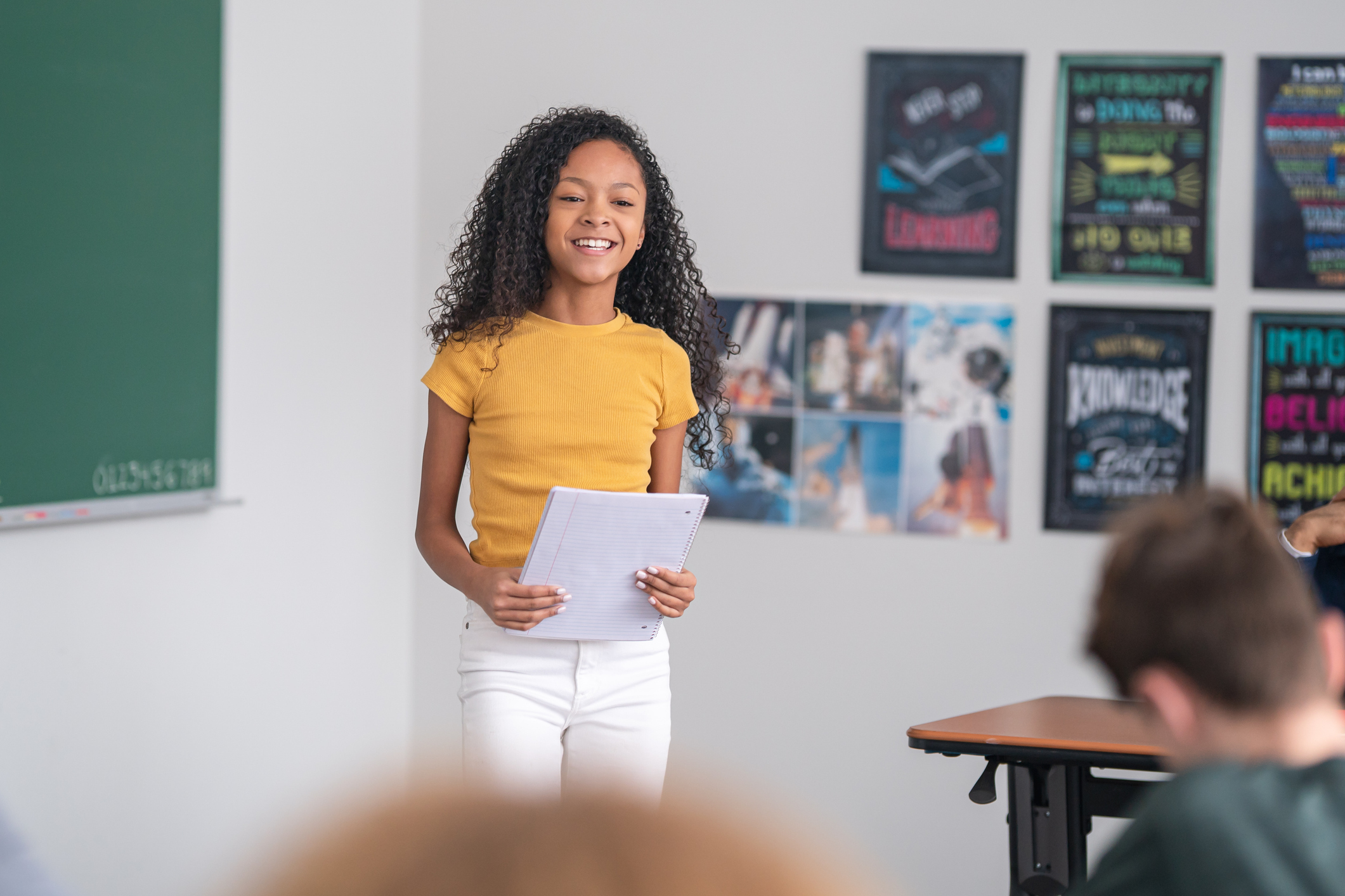 Photo of a student presenting a report to her fellow students