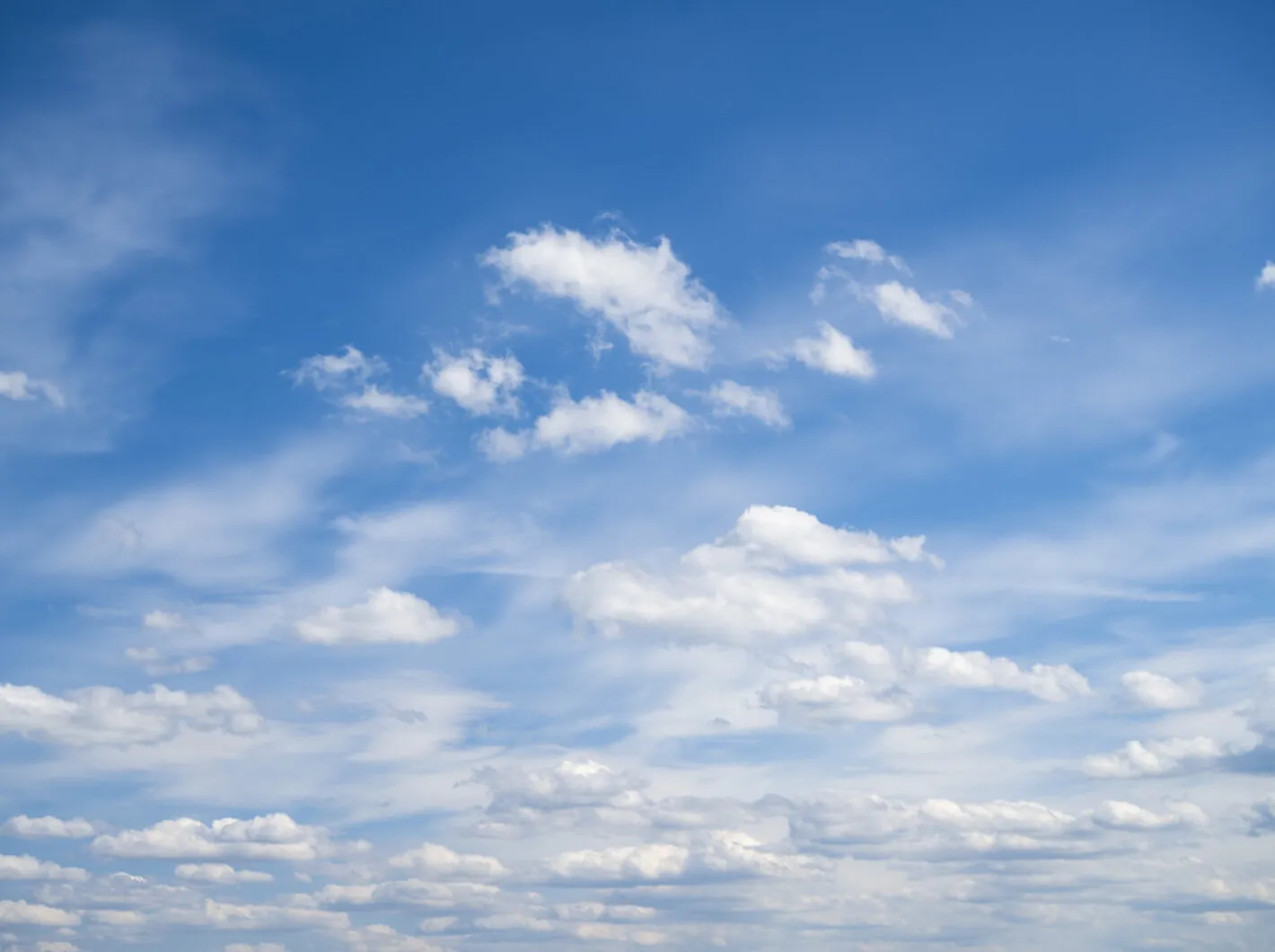 Bright blue sky with scattered white clouds