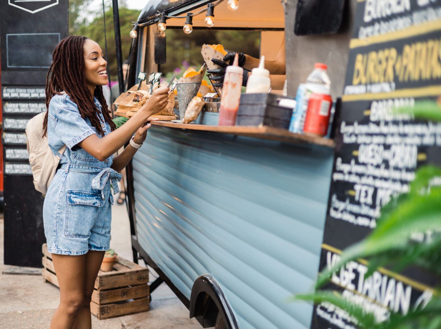 Photo of a woman receiving food at a food truck