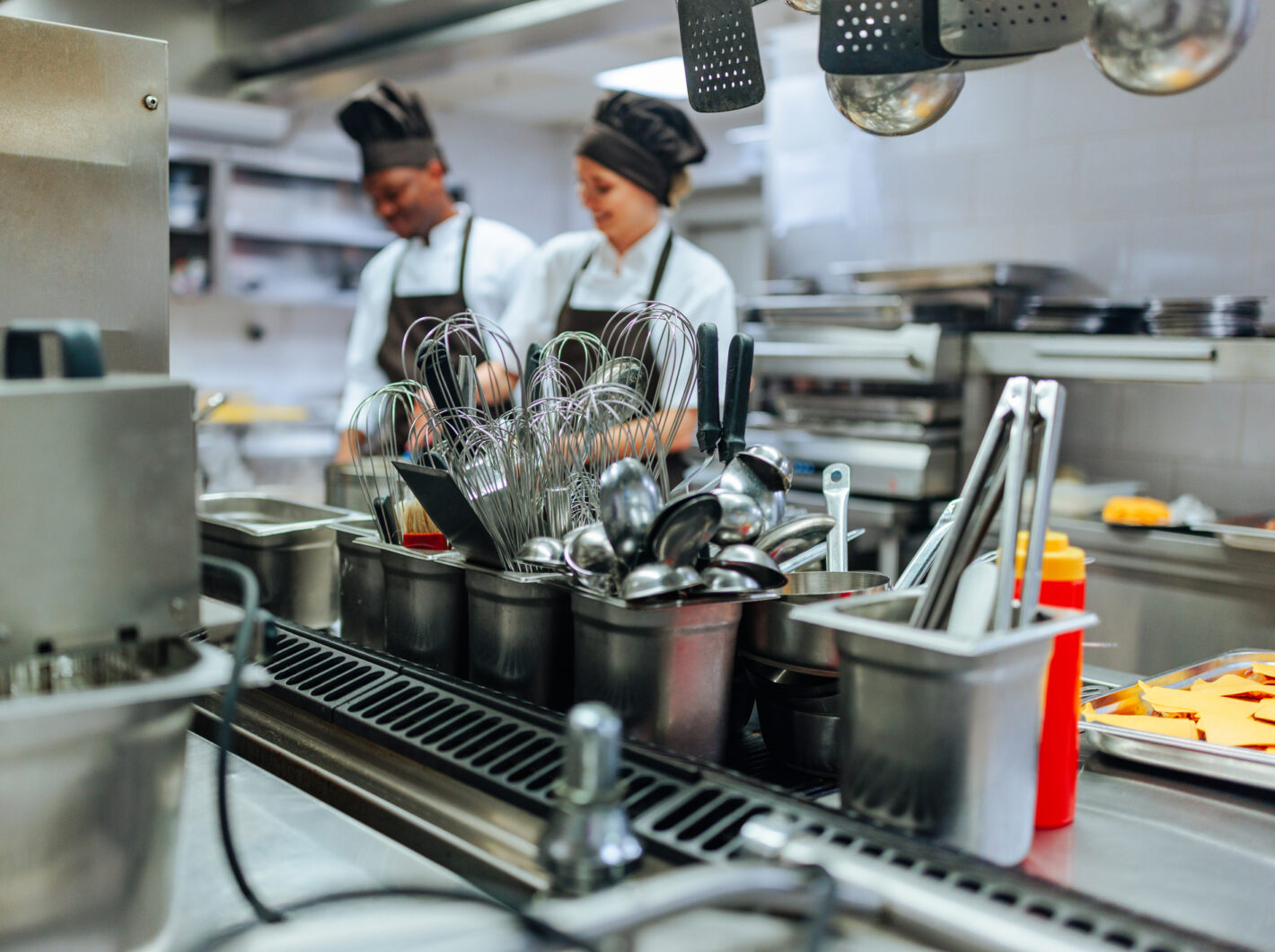 Photo of a commercial kitchen with two chefs at work